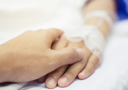 Patient hand in hospital bed