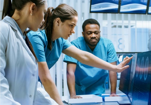 Group of lab technicians reviewing data to increase efficiency by automating sample registration, centrifugation, decapping, recapping and aliquoting.